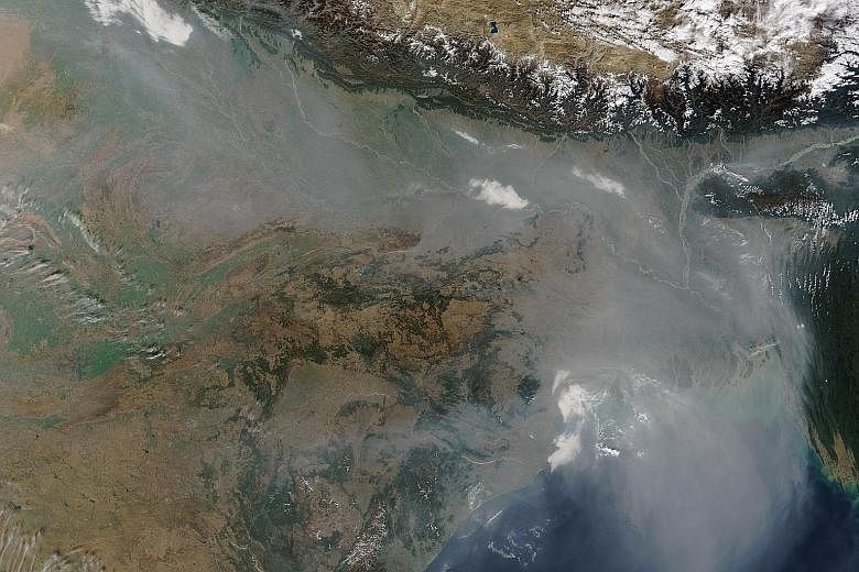 A Nasa satellite image showing a thick blanket of haze hovering over the Indo-Gangetic Plain on Jan 3, darkening skies over northern India and Bangladesh.