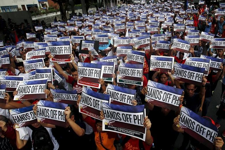 Activists protesting outside the Chinese consulate in Manila ahead of a UN ruling on the South China Sea. However, the Philippines' leadership has taken a more conciliatory tone, saying it is open to joint use of resources in the sea.