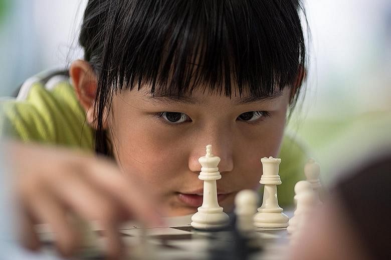 A young girl pondering her next move during an outdoor chess activity at the Central Harbourfront in Hong Kong. Many grown-up Hong Kongers are reportedly also weighing their next step: To remain in Hong Kong or emigrate to another country?