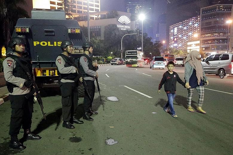 Indonesian police officers boosting security in Jakarta on Tuesday, the last day of the holy month of Ramadan, after a suicide bomb attack in Solo, Central Java. Security analysts say the bombing may be part of coordinated strikes around the world du