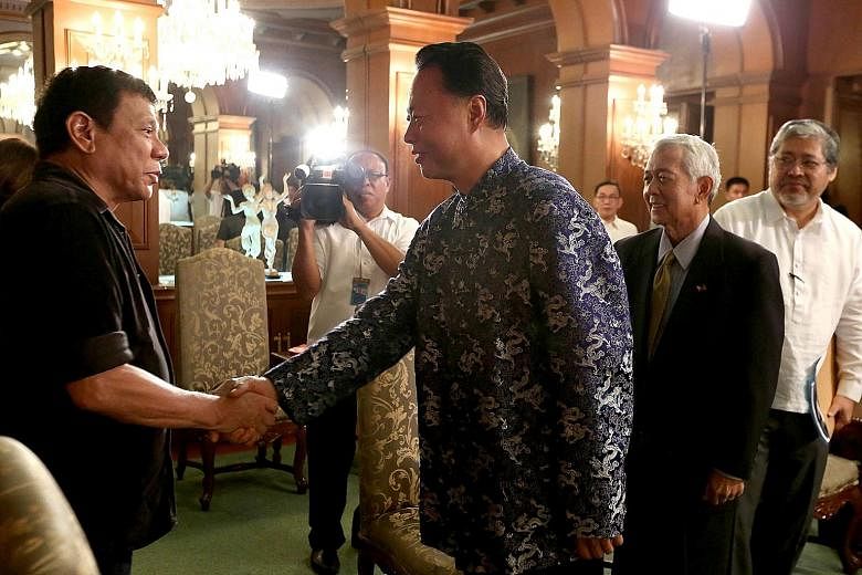 Philippine President Rodrigo Duterte (left) greeting Chinese Ambassador to the Philippines Zhao Jinhua, who made a courtesy call at the Malacanang palace in Manila on Thursday.
