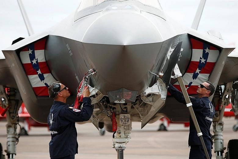 Ground crew working on an F-35A at the Royal International Air Tattoo in Fairford, Britain. The jet was making its first appearance at the world's largest military air show as part of a larger drive to bolster Nato's defences in Europe.