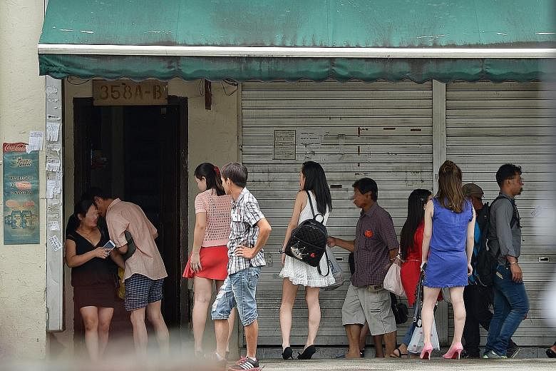 Sex workers used to be a common sight in Geylang (left) as they worked in brothels or plied the streets under the watchful eye of pimps (right). But the rise of the Internet has led to a new group of Geylang prostitutes - freelancers, who rent apartm