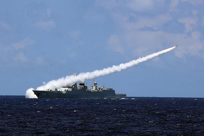 China's missile destroyer Guangzhou launching an air-defence missile during the military drills in the South China Sea last week. The drills focused on "air-control operations, sea battles and anti-submarine warfare", said the PLA Daily, the Chinese 