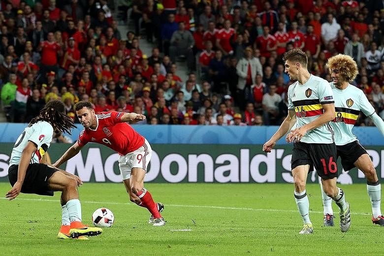 Hal Robson-Kanu (in red), whose contract with English second- tier side Reading has expired, bamboozling the Belgium defence to put Wales 2-1 up, setting them on their way to a memorable last-eight victory.
