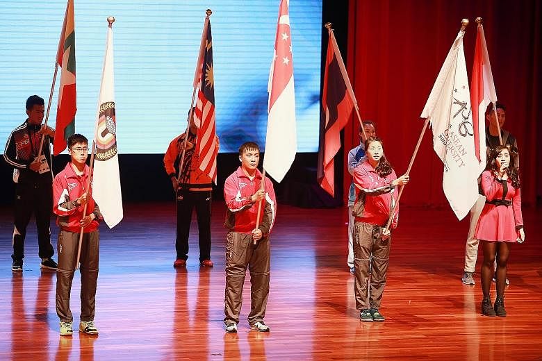 Paddler Pang Xue Jie and flag-bearers from 10 other regional countries at the Asean University Games' opening ceremony. He missed last year's home SEA Games and wants a gold medal to make up for it.
