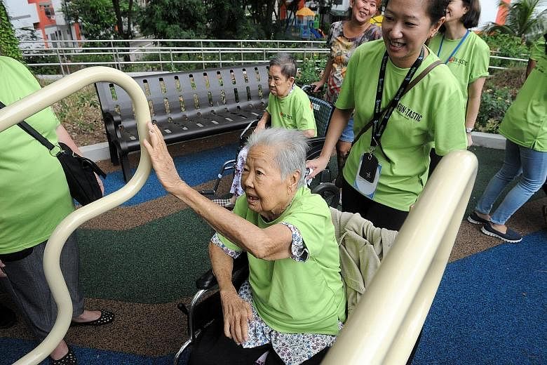 Seniors trying out the exercise equipment at the fitness corner. Republic Poly students and StanChart volunteers were there to help.