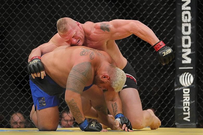Brock Lesnar (right) hitting Mark Hunt en route to claiming the heavyweight title by unanimous decision, making his return to the UFC a victorious one.