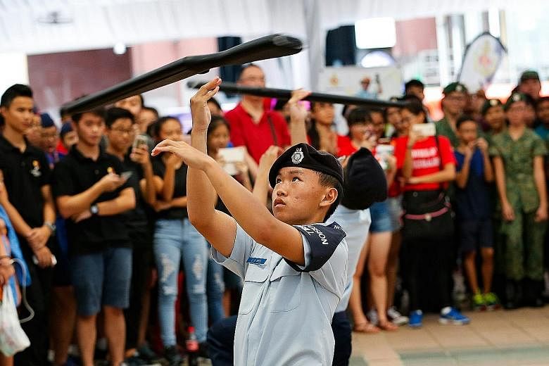Catholic High School students performing a precision drill with wooden rifle replicas at the Uniformed Groups Carnival yesterday.