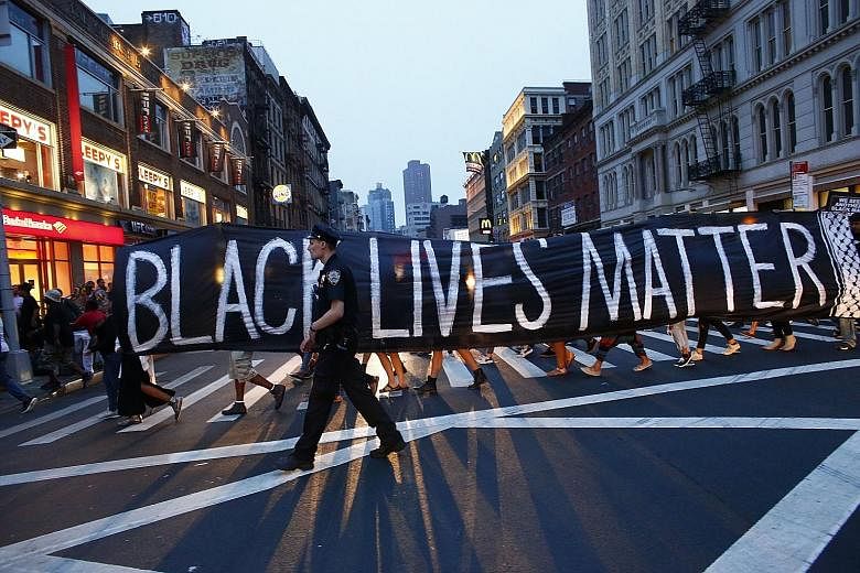 A police officer on patrol during a Black Lives Matter rally in New York last Saturday. Racial issues continue to divide Americans and amid the din of claims and counterclaims, saner voices are calling for a proper and real dialogue.