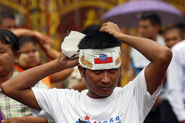 A protester donning a bandana bearing the Rakhine flag during a Yangon street rally to oppose a government order that the media use the phrase "Muslims in Rakhine State" to refer to the state's population who practise the Islamic faith. The Ministry 