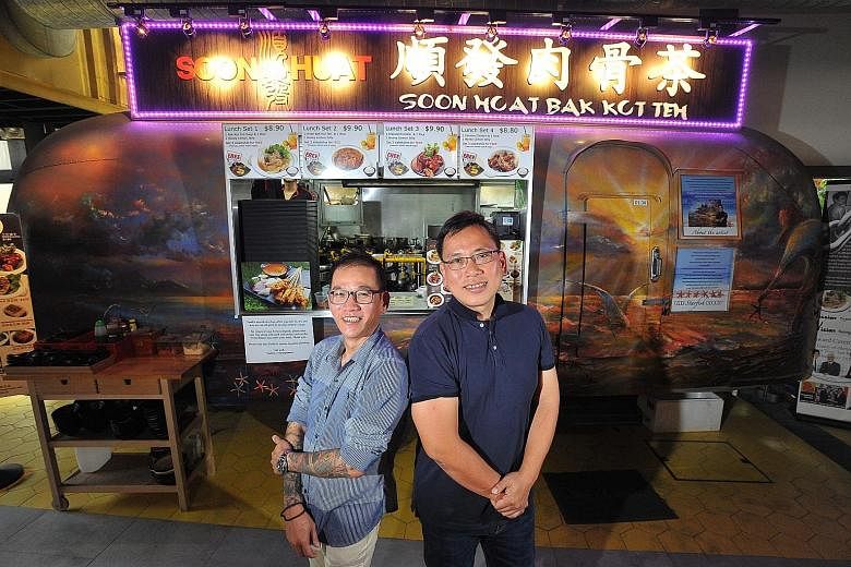 Mr Wu, (in dark blue shirt) and Mr Yeow at the Soon Huat Bak Kut Teh stall at Timbre+. The two teamed up with social entrepreneur Jabez Tan to pilot a project that will help marginalised groups in society, such as former offenders.