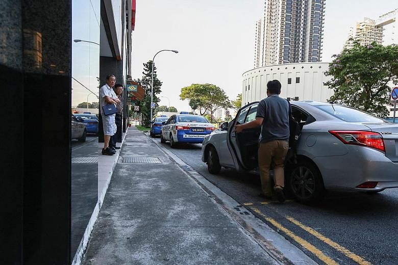 A passenger boarding an Uber car at Bishan Junction 8. Private-hire operators cannot pick up street-hailing customers, who make up 80 per cent of cab trips.