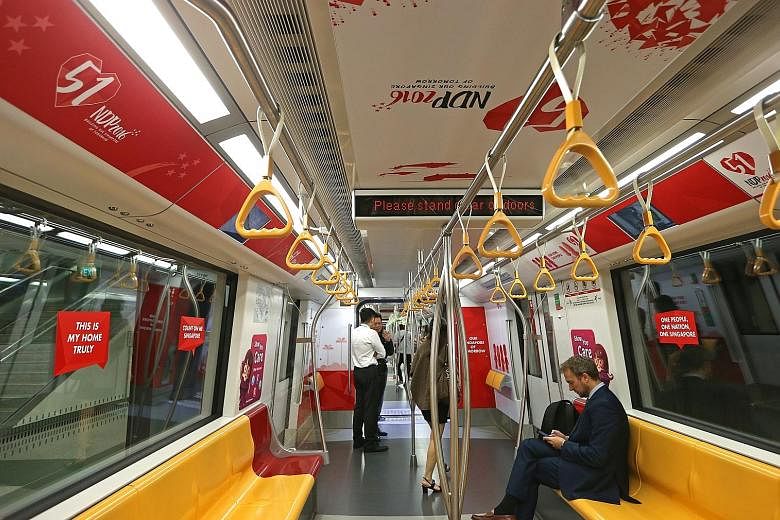 Four trains awash in red and white will be running on different MRT lines until mid-August. Two of them began service yesterday.