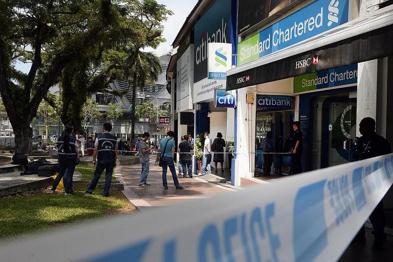 The suspect, a Canadian, fled Singapore last Thursday with $30,000 in cash after robbing StanChart's branch in Holland Village.