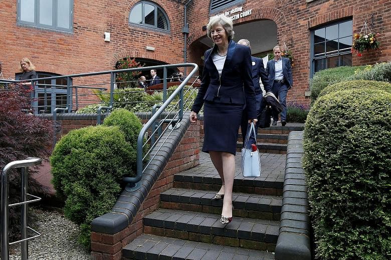 Mrs May, set to become Britain's second female prime minister, at Birmingham's Institute of Engineering and Technology yesterday. In a speech, she called for "a country that works for everyone, not just the privileged few". Mrs Leadsom said a nine-we