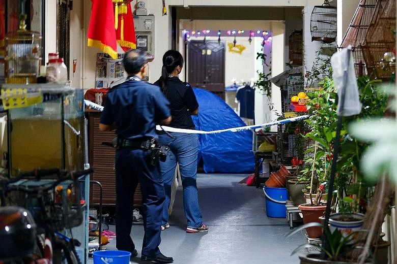 Police at Block 279 in Yishun Street 22 last Saturday, where a 26-year-old man was found lying motionless and pronounced dead.