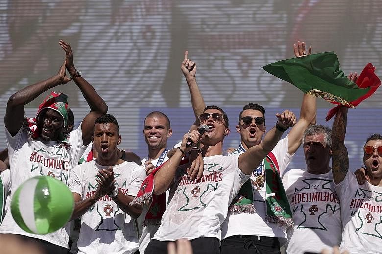 Cristiano Ronaldo (with microphone), his Portugal team-mates and coach Fernando Santos (right) leading celebrations in Lisbon. The Real Madrid forward, who was hauled off during the Euro 2016 final due to injury, may not recover in time for his club'
