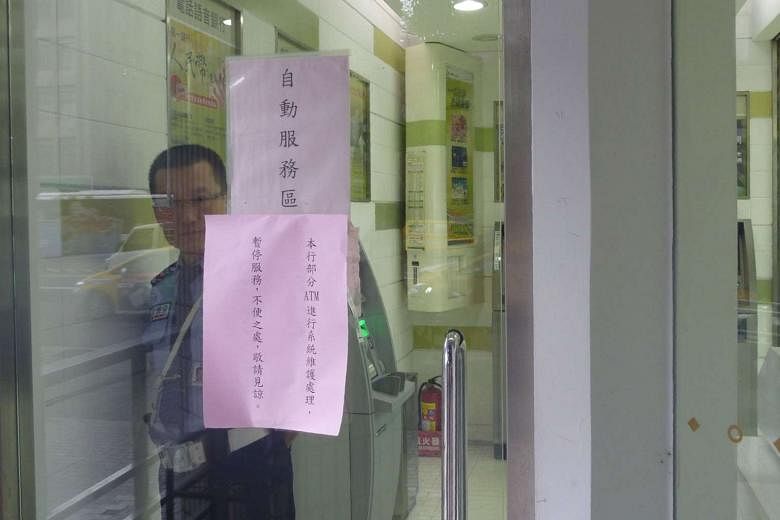 A notice telling customers at a Taipei branch of Taiwan's First Commercial Bank that ATM services have been suspended. The island's top eight banks took the precaution following the discovery on Monday that thieves had hacked 34 ATMs at 20 branches of Fir