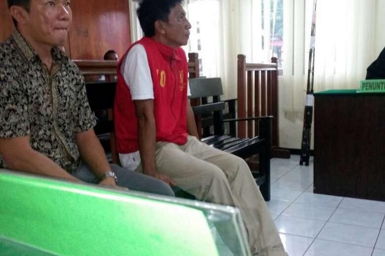 Mr Choo (right), accompanied by a Chinese-language translator in court. He had been arrested in Indonesian waters on April 16, together with 13 passengers. 