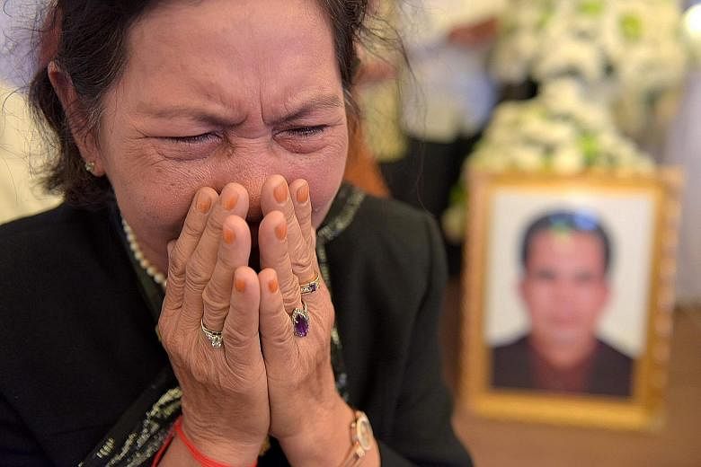 A woman mourning pro-democracy campaigner Kem Ley, who was killed on Sunday, at his funeral in Phnom Penh on Tuesday. The suspect claimed he shot Mr Kem Ley over an outstanding debt.