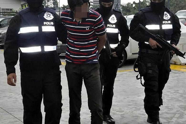 Malaysian police arresting a suspect believed to be linked to terrorist group ISIS. Malaysia is on tenterhooks over security fears following a grenade attack on a nightclub in Selangor more than two weeks ago by ISIS sympathisers.