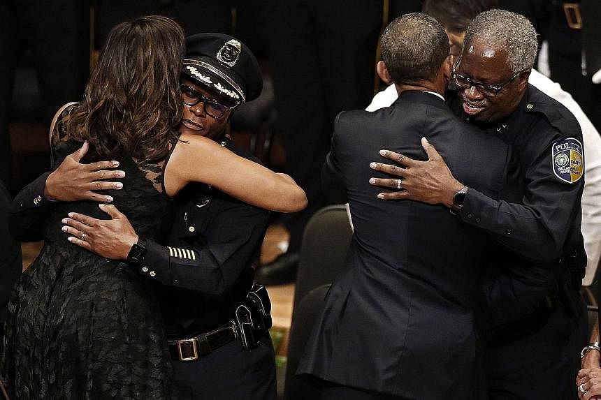 Dallas Police Department Chief David Brown (at left) and Dallas Area Rapid Transit Police Chief J.D. Spiller with the First Couple during the Interfaith Tribute to Dallas Fallen Officers at the Morton H. Meyerson Symphony Centre on Tuesday.