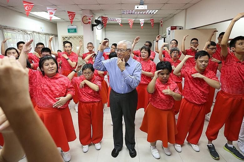 President Tony Tan at a song-signing rehearsal organised by Touch Community Services yesterday. The participants will lead the audience at the National Stadium in hand-signing to Home and Count On Me, Singapore.
