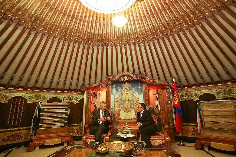 Prime Minister Lee meeting Mongolian President Tsakhia Elbegdorj at the State Palace in Mongolia yesterday. Mr Lee was also hosted to lunch by his Mongolian counterpart Jargaltulga Erdenebat, during which they affirmed the warm and friendly ties betw