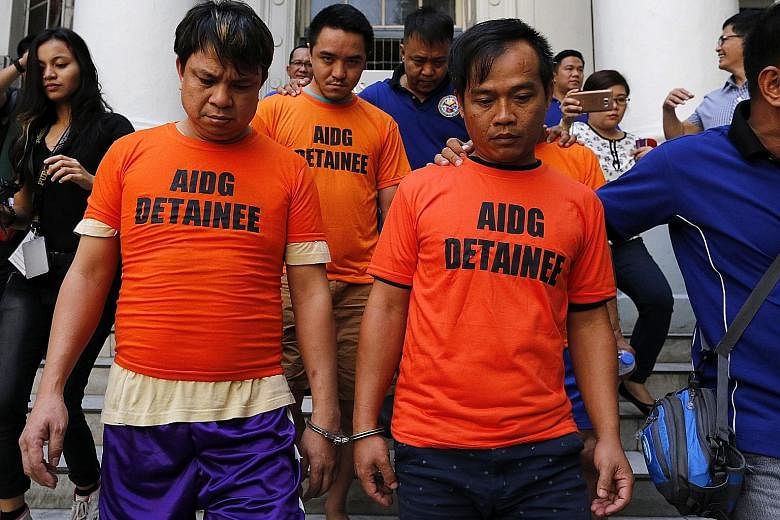 Alleged drug dealers from Hong Kong being escorted to inquest proceedings in Manila on Wednesday. The men were arrested during a raid at a seaport in Olongapo City, Zambales Province. Methamphetamines and equipment used to make illegal drugs were fou