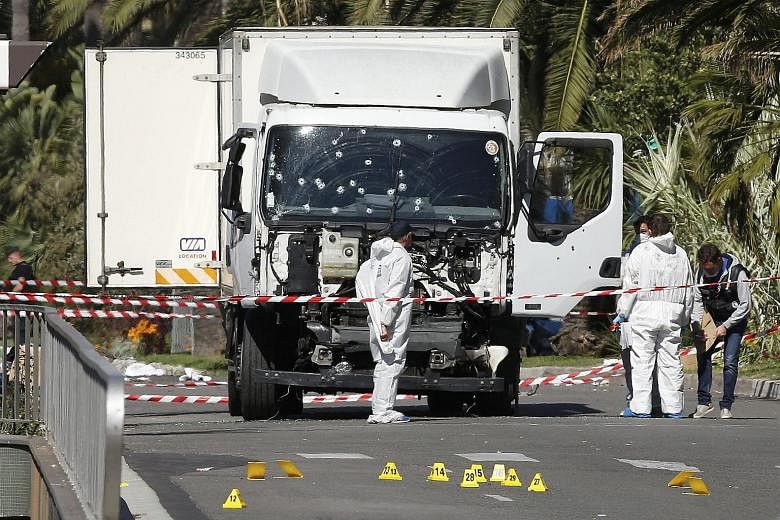 Investigators at the scene yesterday after an assailant rammed his truck down a busy promenade filled with Bastille Day revellers. The entire country was stunned by the attack on the French Riviera city of Nice, which left scores dead.