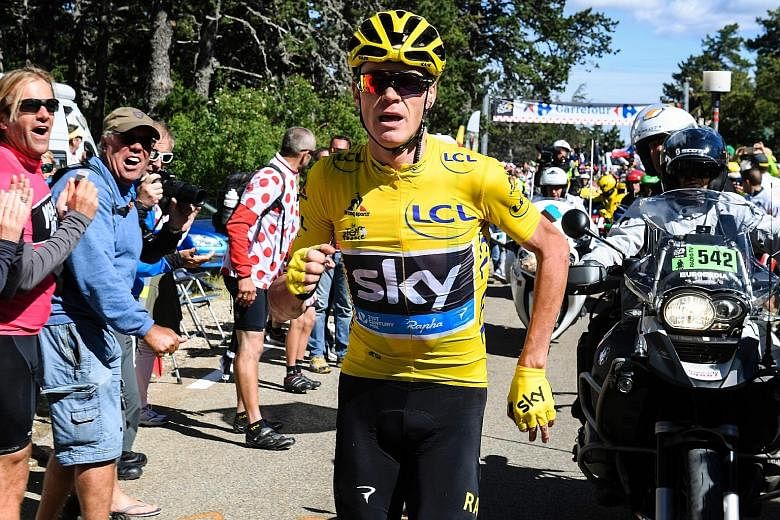 British rider Christopher Froome, wearing the overall leader's yellow jersey, is the running man as he heads up Mont Ventoux for a replacement bike after falling during the 178km 12th stage of the Tour de France. Amid chaos, he lost the lead but was 