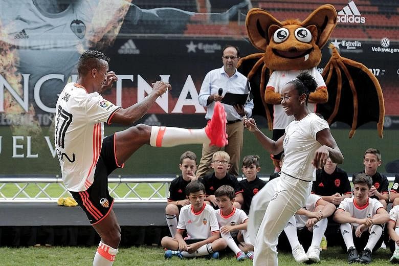 Portuguese forward Luis Nani (left) performing the capoeira, a Brazilian martial art incorporating dance and music, during his presentation as a new player of Valencia held at the Mestalla stadium.