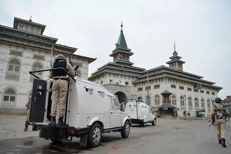 Indian paramilitary patrolling the Dastageer Sahib Shrine in Srinagar, Jammu and Kashmir, to enforce the curfew yesterday.
