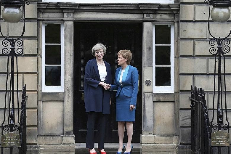Mrs May (far left) greeting Scottish First Minister Sturgeon in Edinburgh, Scotland, in her first foray out of London since becoming the British Prime Minister. Ms Sturgeon said if Scots wanted another independence vote, the British government would 