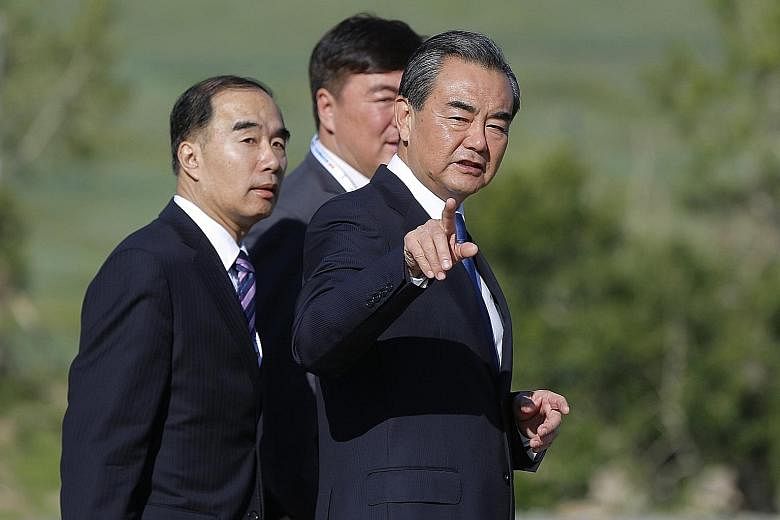 Chinese Foreign Minister Wang Yi (at right) at the Asia-Europe Meeting summit in Ulaanbaatar yesterday. China had asserted that it did not want the South China Sea to be discussed, saying the venue was not appropriate.