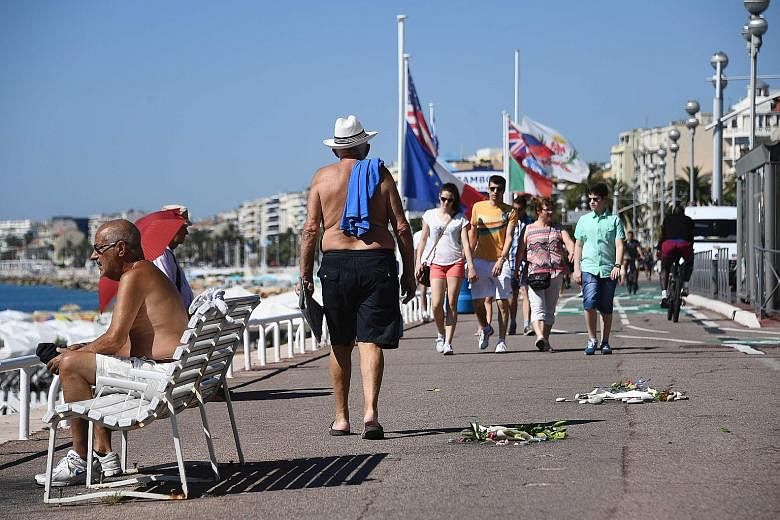 Flowers left as tributes to the victims of last Thursday's attack on the Promenade des Anglais in Nice yesterday.