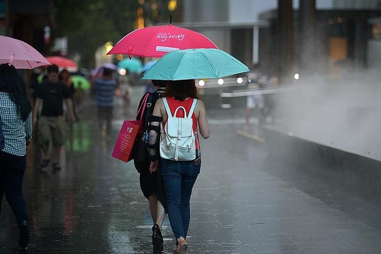 Just like these shoppers caught in the rain, mall landlords in Singapore are also facing gloomy weather, as e-commerce growth outpaces retail sales.