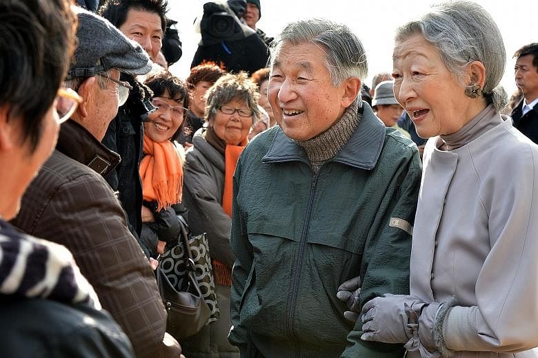 Emperor Akihito and Empress Michiko meeting well-wishers in Kanagawa prefecture in this 2013 photo. The soft-spoken monarch has been known to kneel to speak eye-to-eye to the injured and those in wheelchairs.