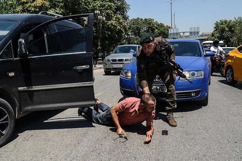A police officer restraining a man during an operation in Ankara yesterday. The swift retribution for the coup bid has drawn concern from Turkey's Western allies. Police special forces at the air force academy in Istanbul yesterday. A senior security