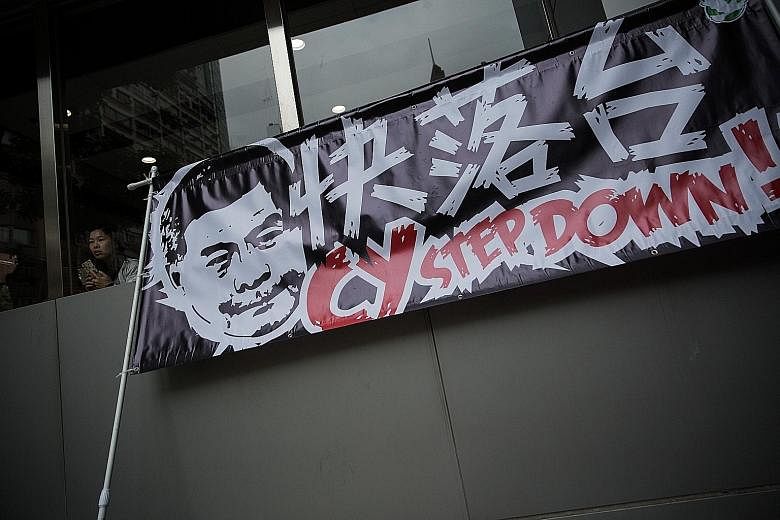 A protest banner on May 18 calling for Mr Leung to step down. Hong Kong is mired in governance paralysis due to a toxic relationship between the government and legislators.