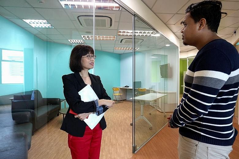 Sana para-counsellor Koh Joh Ting having a chat with Mr Ridzwan at the Step-Up Centre. Besides counselling and mediation services, the centre also provides legal aid and financial help.