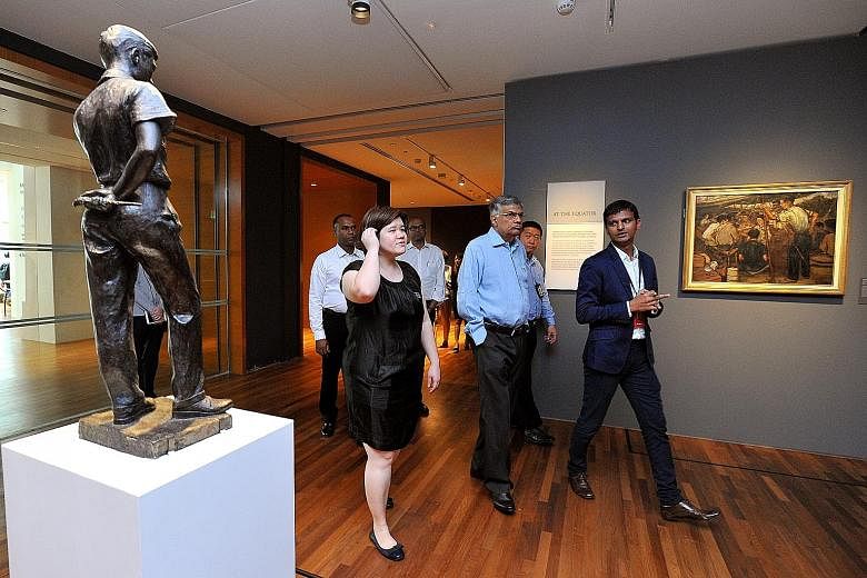 Sri Lankan Prime Minister Wickremesinghe (centre, in light blue) taking a tour of the National Gallery yesterday. Mr Wickremesinghe said he was impressed by Singapore's development and was keen to find out how colonial-era buildings were conserved.
