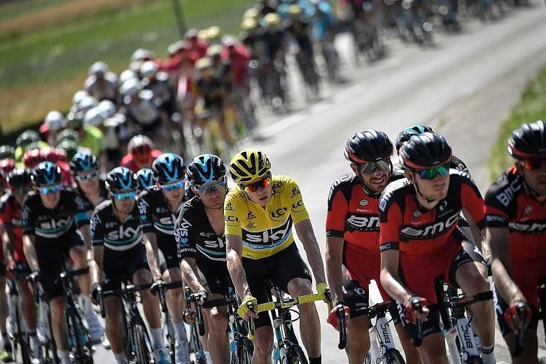 Team Sky's Chris Froome, wearing the leader's yellow jersey, in the pack during the 16th stage. He considers today's 17th stage, with an uphill finish, extremely tough.