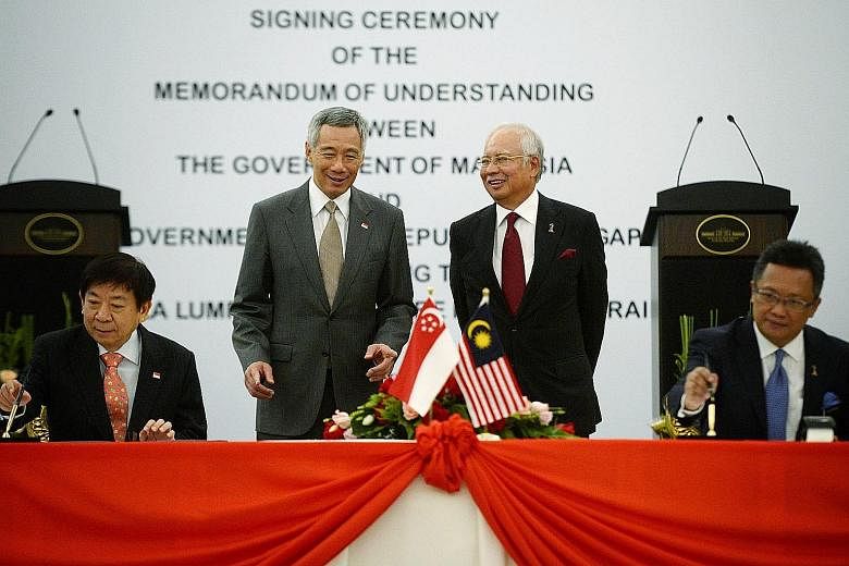 PM Lee and Mr Najib witnessing the signing of the high-speed rail MOU by Mr Khaw and Mr Abdul Rahman in Putrajaya yesterday. Three services will run along the rail line that will have eight stations, of which one will be in Singapore - at Jurong East