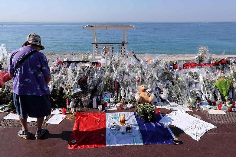 The new site yesterday of the makeshift memorial to the victims of the deadly Bastille Day attack in Nice after it was moved from the road pavement to the seafront so that the street can be re-opened.