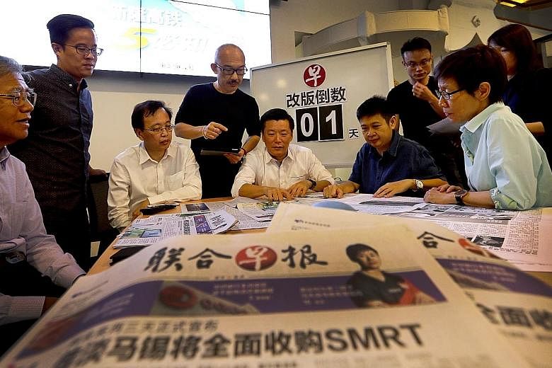 Lianhe Zaobao editor Goh Sin Teck (seated, centre) in discussion with other senior editors on enhancing the paper's reading experience for its audience. The revamped Chinese daily hits the streets today with new content and design.