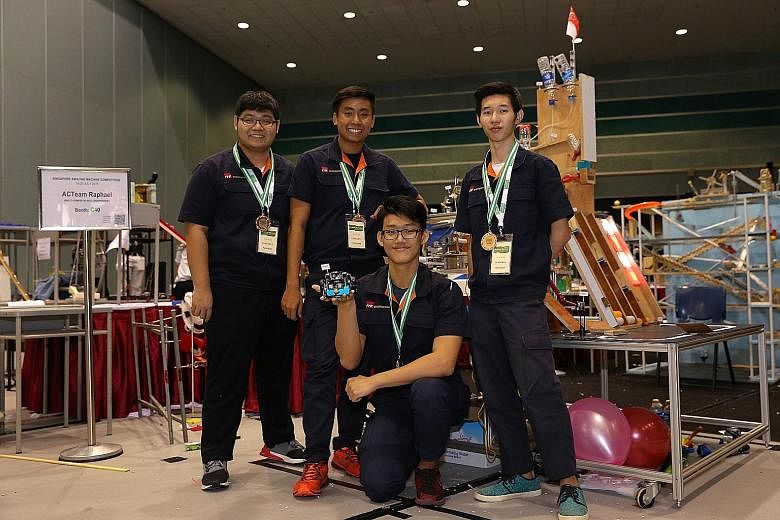 Poh Wei Jie (above, right), 17, the leader of the CCKRanger team from ITE College West, yesterday explaining to Mr Ong Ye Kung, Acting Minister for Education (Higher Education and Skills), the workings of his team's Rube Goldberg machine, which won t