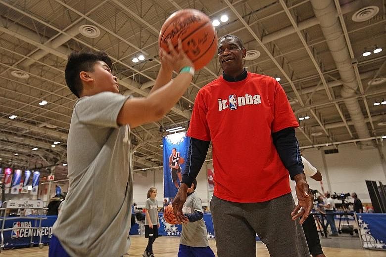 Dikembe Mutombo, one of the NBA's greatest defensive players, teaching kids on Jr NBA Day in February in Toronto.
