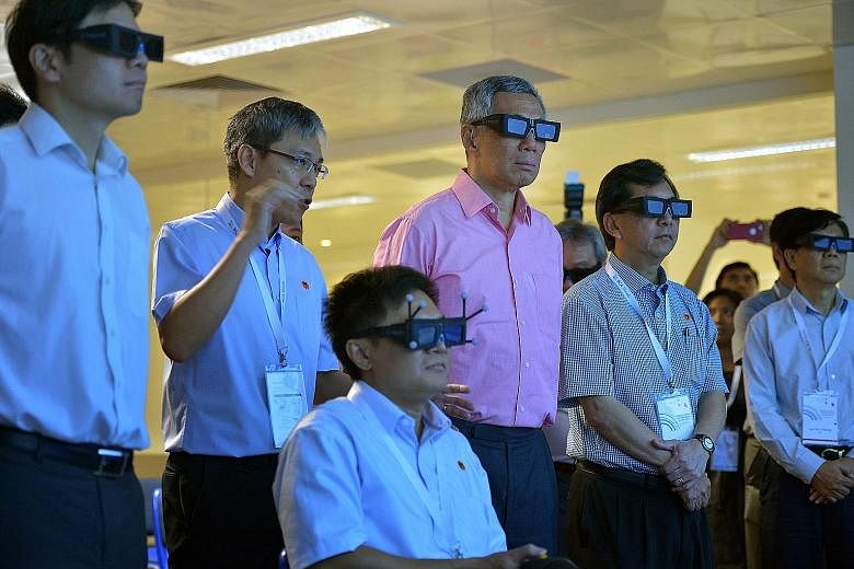 PM Lee taking a virtual tour of Changi Airport's upcoming Project Jewel at the BCA's Centre for Lean and Virtual Construction yesterday with BCA chief executive John Keung (second from right) and National Development Minister Lawrence Wong (far left)
